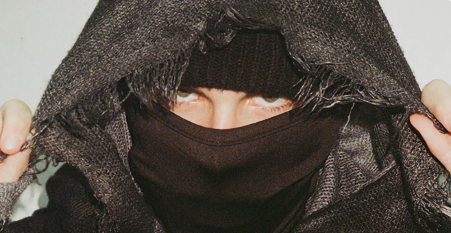 Why Does EsDeeKid Cover His Face?